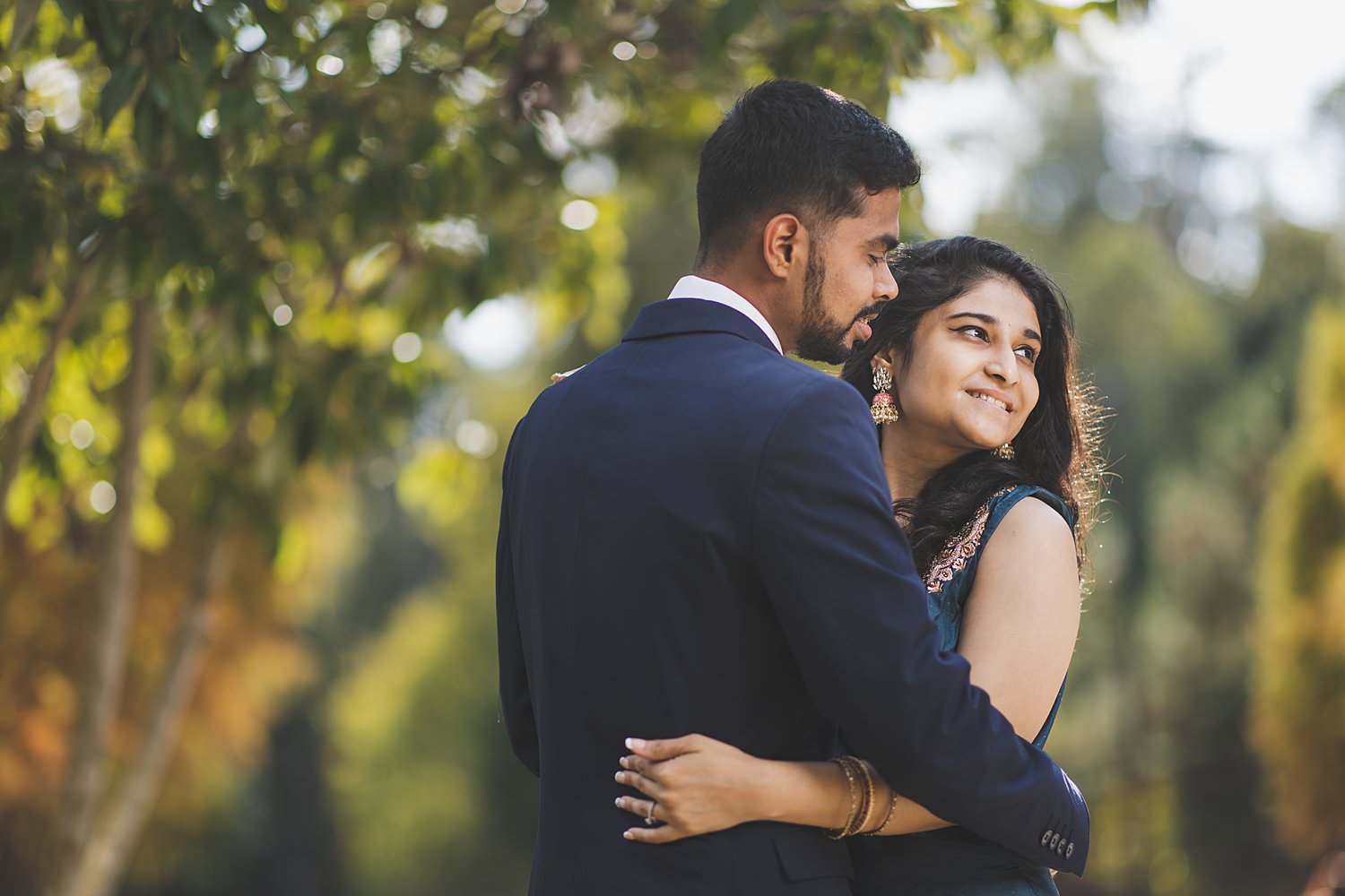 Indian couple posing outdoors for engagement photo session. | Photo 259964